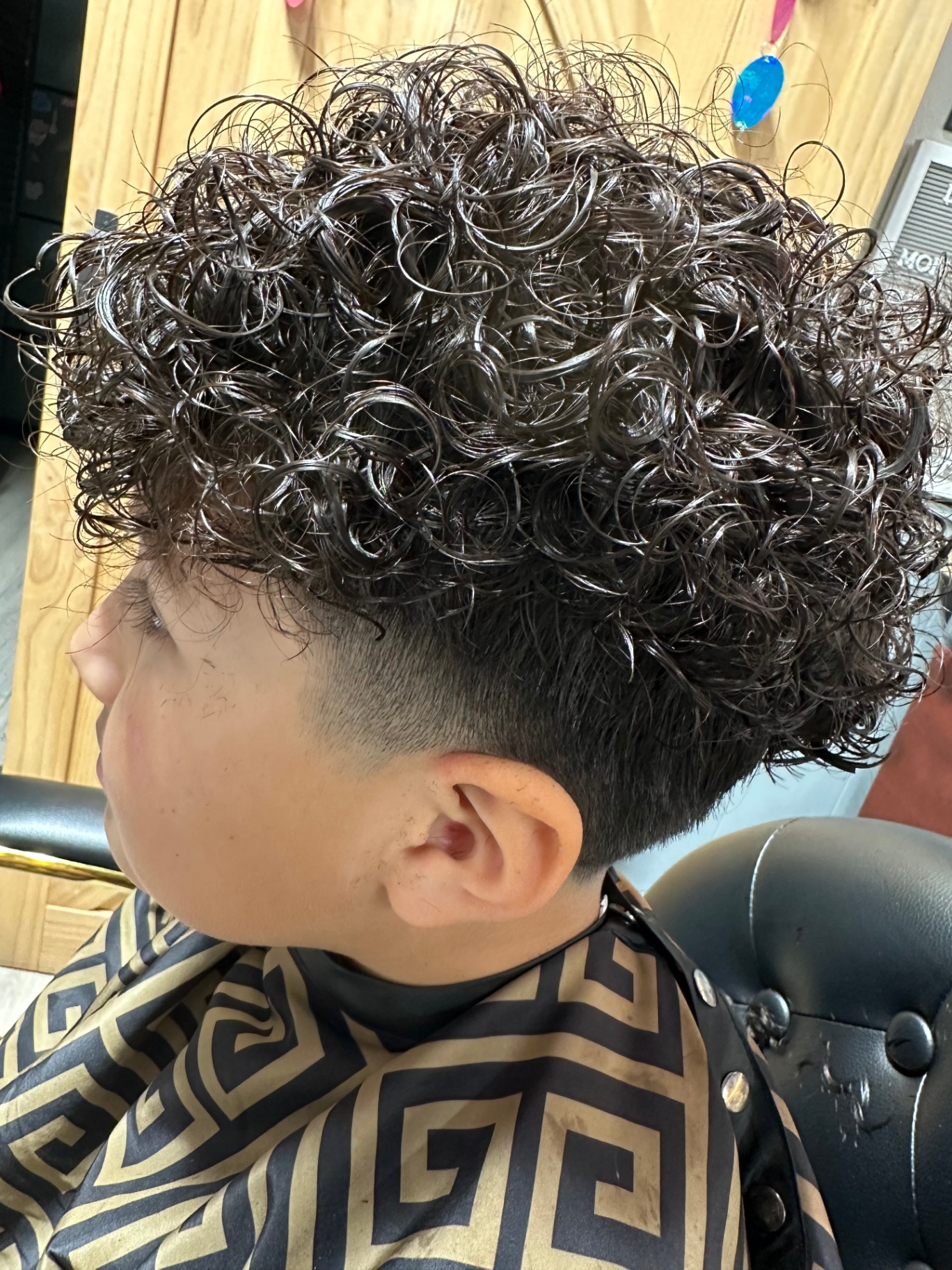 Loose curls with clean low fade